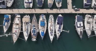 Aerial view of luxurious expensive yachts moored in the marina. Motor boats are anchored in the port. High quality 4k footage