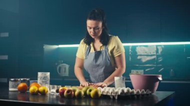 Beyaz kadın mutfağa hamur atıyor. Şef pasta yapmak için bir pasta hazırlıyor. Evde hazırlanmış şekerler. Yüksek kalite 4k görüntü