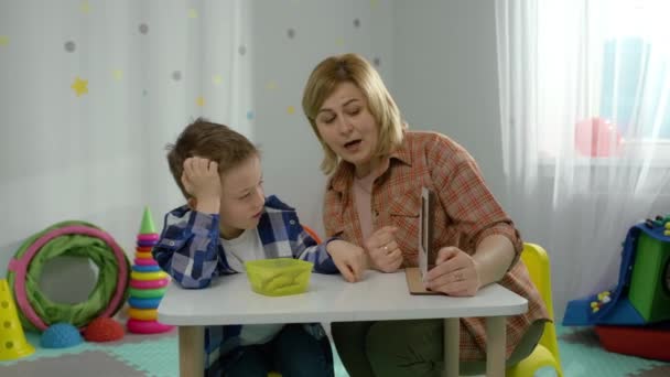 Teacher Shows Boy How Correctly Complete Logic Tasks Kindergarten Child — стоковое видео