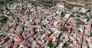 Aerial view of Lefkara cityscape, Cyprus. A panoramic view of the historical mito with architecture of red roofs and stone houses. High quality 4k footage