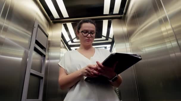 Elinde Belgeleri Bilgisayarı Olan Bir Kadını Asansördeki Bir Toplantısına Gider — Stok video