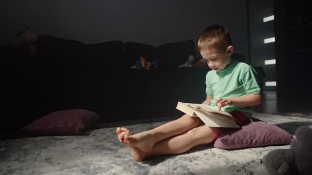 Child Boy Holding Book His Hands Reads Fairy Tale Home — Stock Video