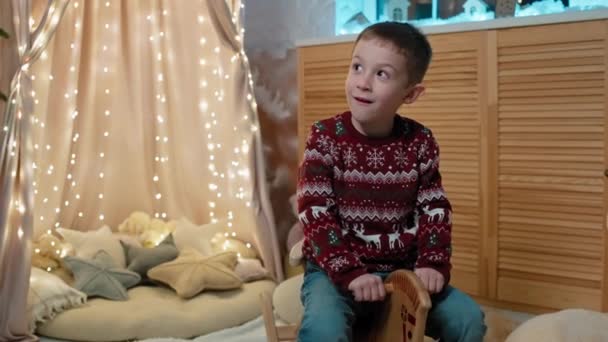 Joyful Christmas Playtime Smiling Boy Festive Room Decor Child Riding — Vídeo de Stock