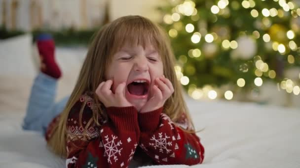 Retrato Una Niña Caucásica Sonriente Una Cama Cerca Árbol Navidad — Vídeos de Stock