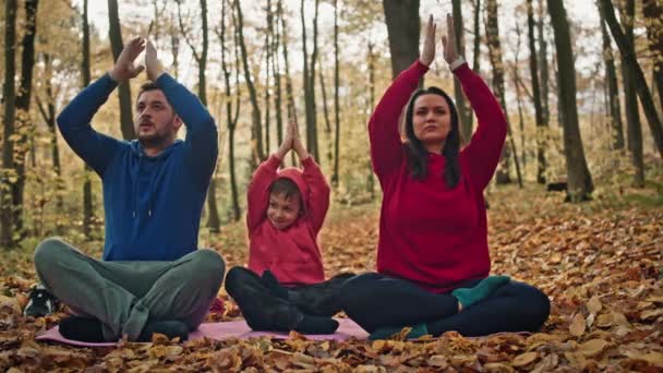 Caucasian Parents Son Meditating Yellow Autumn Leaves Family Yoga Practices — Stock Video