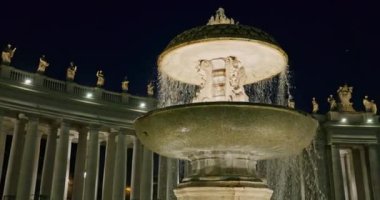 Cityscape of the night Fountains of St. Peters Square, Rome, Italy. Buildings illuminated by street lighting in the historical center of the capital. High quality 4k footage