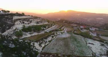 Kıbrıs Rum Kesimi Sunset Splendor: Dağlık Manzaralarda Hava Aracı Üzüm bağları ve Şarap Yapımı Manzaraları. Yüksek kalite 4k görüntü