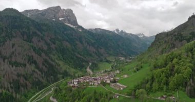 Rocca Pietore İtalya 'nın hava manzarası. Dolomite Alplerindeki tepe ve dağ sıralarının eteklerindeki şehir. Yüksek kalite 4k görüntü