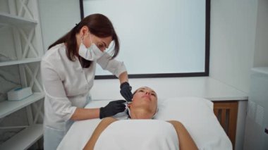 Bir kozmetikçi bir kadın üzerinde biyo-evrim işlemi gerçekleştirir. Güzellik prosedürleri, kızların yüzüne yapılan iğneler güzellik ve sağlık kozmetoloji kliniği. Yüksek kalite 4k görüntü