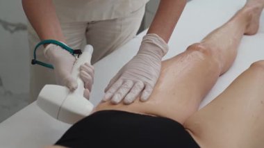 Güzellik kliniğinde lazer tüy çıkarma prosedürü. Güzellik uzmanları, uzun süreli pürüzsüzlük, cilt bakımı ve kişisel bakım için kadın bacakları tedavi eder. Yüksek kalite 4k görüntü