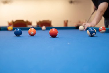 of a man's hand on a billiard table, playing snooker, preparing to shoot billiard balls, sport game snooker billiards, billiard balls