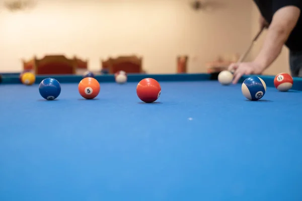 stock image of a man's hand on a billiard table, playing snooker, preparing to shoot billiard balls, sport game snooker billiards, billiard balls