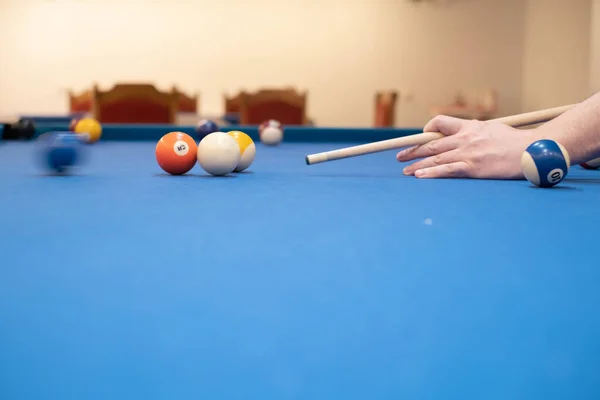 stock image of a man's hand on a billiard table, playing snooker, preparing to shoot billiard balls, sport game snooker billiards, billiard balls