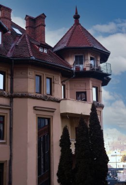 an old building with a red roof in the background blue sky