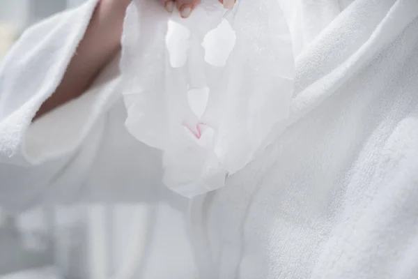 Woman Sheet Mask Her Hands Bathroom Applying Her Face — Stock fotografie