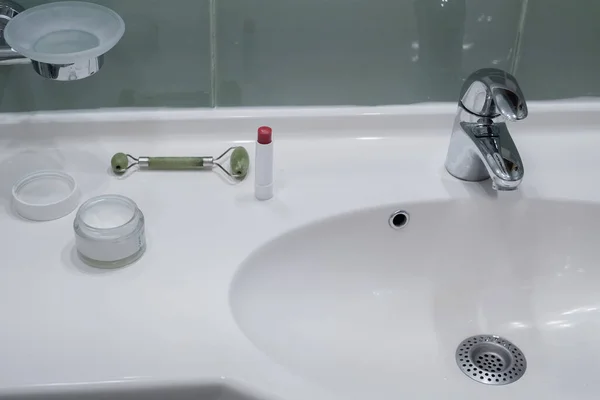 Face Cream Face Roller Lipstick Sink Counter Bathroom Space Text — стоковое фото