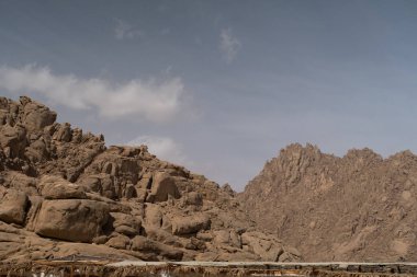 Sinai mountains at daytime, blue sky, top view of the mountains, colorful canyon at sunset in Egypt