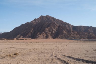 Sinai mountains at daytime, blue sky, top view of the mountains, colorful canyon at sunset in Egypt