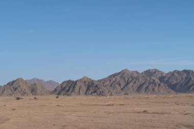 Sinai mountains at daytime, blue sky, top view of the mountains, colorful canyon at sunset in Egypt
