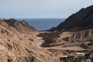 Sinai mountains at daytime, blue sky, top view of the mountains, colorful canyon at sunset in Egypt