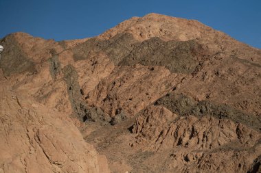 Sinai mountains at daytime, blue sky, top view of the mountains, colorful canyon at sunset in Egypt