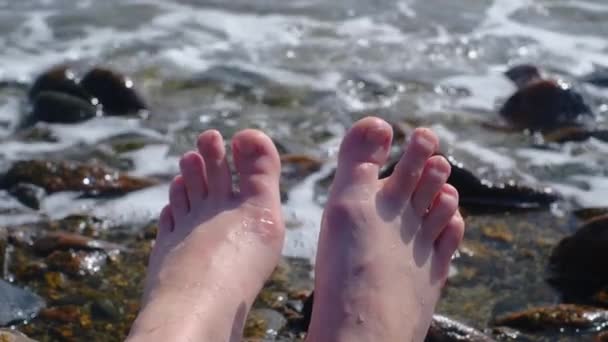 소녀의 다리를 클로즈업한 파도에 되었습니다 해수욕장에서 다리에 한바다 — 비디오
