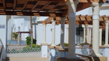 Çardağın ahşap yapısı, çardağı koruyan yumuşak silindirik beyaz sütunlar tarafından desteklenmektedir. Çatı, tuğladan çatılı bir istinat duvarına bağlı, camla kaplıdır.