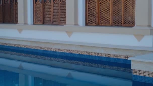 带有木制百叶窗的石屋 木制百叶窗 游泳池 棕榈树的旧时代窗户全景 — 图库视频影像