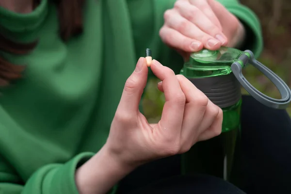 Girl Holds Vitamins Her Hand Bottle Spring Forest Dressed Green — Stock Photo, Image