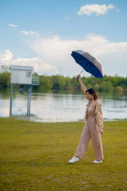 Umbrella in woman's hand as she runs, light summer rain, umbrella symbolizes seasonal discounts and special offers. clipart