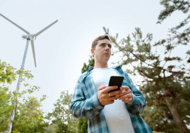 Wind turbine electrician connecting the electrical system, including transformers, inverters, and batteries for efficient operation. clipart