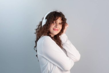Kadın gülüyor ve dans ediyor, müzik ve hareketin onun terapisi olduğu anın tadını çıkarıyor..