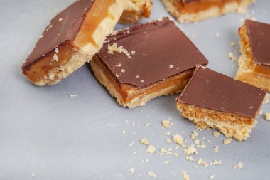 Rustic style millionaires shortbread blocks with crumbs