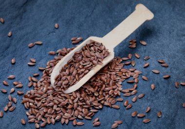 scoop of flax seeds on black