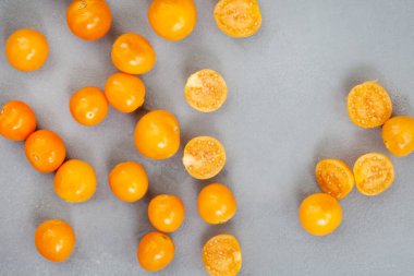 cape gooseberry flat lay on mottled grey.