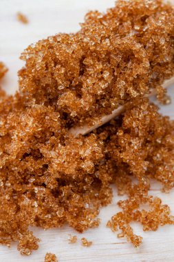 Wooden scoop with muscovado or brown sugar