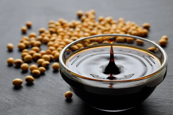 Soy Sauce Spalsh Drop Glass Bowl Dry Soybeans Black Stone — Stock Photo, Image