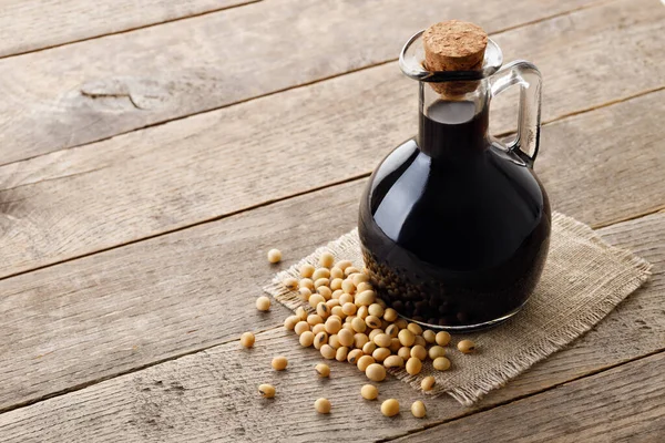 Soy Sauce Glass Bottle Dry Soybeans Gray Wooden Table — Stock Photo, Image