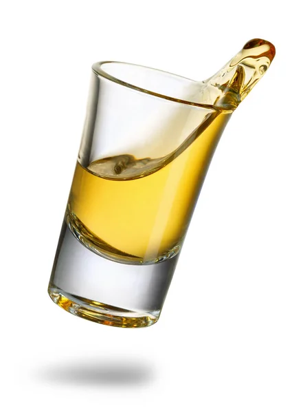 stock image falling tequila shot with splash isolated on white background