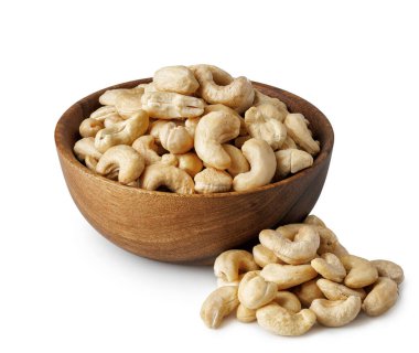 Tahta kasede kaju fıstığı ve beyaz arka planda izole edilmiş yakınlarda istiflenmiş. Dosya kırpma yolu içeriyor