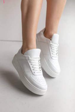 Fashionable stylish leather sports casual shoes.white stylish sports shoes shoes on feet close-up. without face