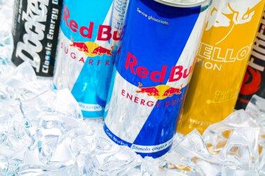 TRIESTE, ITALY-MAY 30, 2016: Aluminium can of Red Bull Energy drink on ice is sold by Austrian company Red Bull GmbH, created in 1987. Red Bull is the most popular energy drink in the world, with 5,226 billion cans sold in 2012.