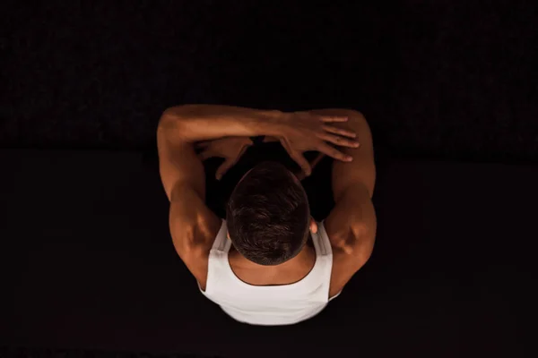 stock image A man holds his knees with his hands doing yoga. Top view. High quality photo