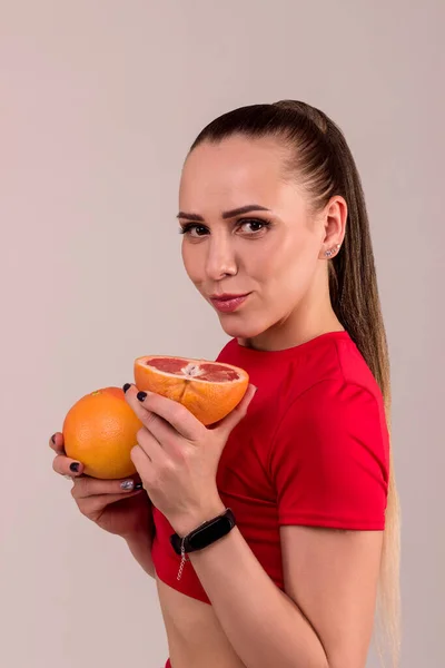 Young Woman Red Suit Holds Cut Grapefruit Her Hands High — Stock Photo, Image