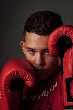 Genç bir boksör, karanlık arka planda boks eğitimi alıyor. Agresif bir spor. Yüksek kalite fotoğraf