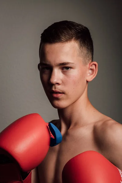一名青少年拳击手正在训练如何在黑暗的背景下打拳 好斗的运动高质量的照片 — 图库照片