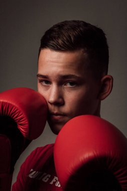 Genç bir boksör, karanlık arka planda boks eğitimi alıyor. Agresif bir spor. Yüksek kalite fotoğraf