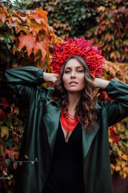 Kafasında sonbahar çelengi olan güzel bir Ukraynalı kadın. Sonbahar akşamı. Toplanıyoruz. Yüksek kalite fotoğraf