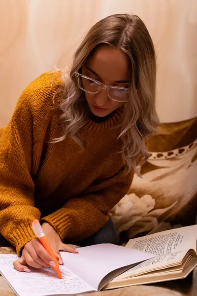 Woman at home reading a book. Female student doing homework. Reading a novel. High quality photo