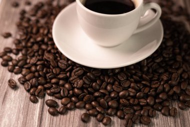 Bir fincan espresso kahvesi. Kahve çekirdeğinin üzerinde bir fincan kahve standı. Kafeinsiz kahve. Yüksek kalite fotoğraf